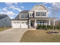 Charming two-story home with a three-car garage and a beautifully landscaped front yard at 531 Catfish Lake Dr, Fuquay Varina, NC 27526