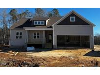 New construction home features a two-car garage and front porch at 40 Dark Night Ln, Zebulon, NC 27597