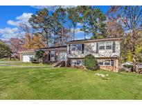 Charming split-level home featuring a brick facade and a well-manicured lawn at 503 Marshall Way, Durham, NC 27705
