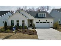 Charming single-story home with white siding, manicured landscaping, and a two-car garage at 2229 Abbeyhill Dr # 123, Raleigh, NC 27610