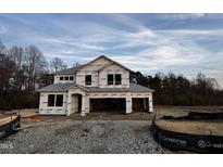 Two-story house under construction, gray roof, HomeGuard wrap at 23 Barrow Ct, Angier, NC 27501