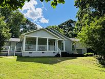 Charming single-story home with a welcoming covered front porch and a well-maintained lawn at 135 Weatherbend, Pittsboro, NC 27312