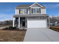 Two-story home featuring stone accents, a two-car garage, and an 'available' sign at 150 Steppe Way, Garner, NC 27529