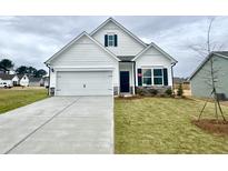 Charming two-story home with a well-manicured lawn, inviting entrance, and a two-car garage at 174 Vega Loop, Sanford, NC 27330
