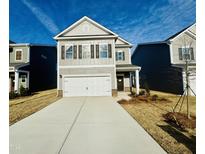 Charming two-story home with a concrete driveway and a two-car garage at 108 Commons Circle # 228, Clayton, NC 27520