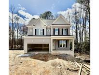 Charming two-story home with gray siding, black shutters, and an attached two-car garage at 2624 Silver Gate Ct, Wake Forest, NC 27587
