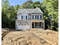 Charming two-story home featuring a gray exterior, black shutters, and an attached two-car garage at 2624 Silver Gate Ct, Wake Forest, NC 27587