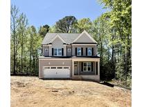 Two-story home with gray siding, black shutters, and attached two-car garage, and landscaping ready at 2624 Silver Gate Ct, Wake Forest, NC 27587