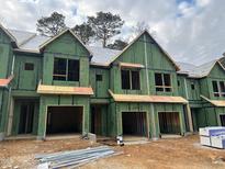 Brand new townhouses under construction, featuring contemporary design and attached garages at 4043 Elk Creek Ln # 15, Raleigh, NC 27612