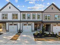 Charming townhome showcasing a well-maintained facade with a welcoming entrance and a two-car garage at 507 Excelsior Ct, Rolesville, NC 27587