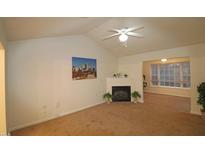 Bright living room with vaulted ceiling, fireplace, and access to other rooms at 11321 Involute Pl # 102, Raleigh, NC 27617