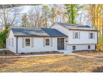 Charming exterior of a bright, two-story home with updated windows and a neatly maintained front yard at 2804 Edgewood Ave, Burlington, NC 27215