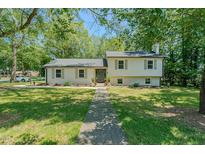 Charming home with a well-maintained lawn and lush greenery, creating a welcoming curb appeal at 2804 Edgewood Ave, Burlington, NC 27215