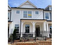 Charming two-story townhome with white siding, black trim, and a wrought iron fence at 478 Traditions Grande Blvd # 32, Wake Forest, NC 27587