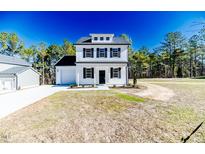 Charming two-story home with white siding, black shutters, and manicured lawn at 806 Roberts Rd, Sanford, NC 27332