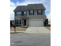 Two-story house with gray siding, two-car garage, and landscaping at 2710 Follow Me Way, Raleigh, NC 27610