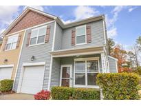 Charming two-story home featuring vinyl siding, shutters, front porch, and attached garage at 3417 Cardinal Lake Dr, Durham, NC 27704