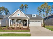 Charming single-Gathering home with a two-car garage, well-manicured lawn, and covered front porch at 800 Heathered Farm Way, Apex, NC 27523