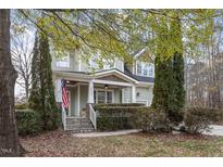 Charming two-story home featuring a covered front porch, stone steps, and a manicured front yard with mature trees at 4324 Brighton Ridge Dr, Apex, NC 27539