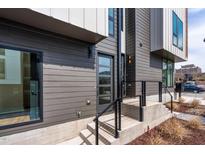 Contemporary home featuring a modern glass front door, stylish gray siding and neat, minimalist landscaping at 512 Gordon Street # 602, Durham, NC 27701