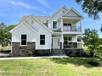 Beautiful two-story home with stone accents, covered porch, and balcony at 89 Jumper St, Wendell, NC 27591