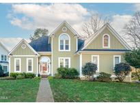 Charming home with manicured lawn, inviting entrance, and a gabled roof, creating a cozy curb appeal at 6625 Arbor Grande Way, Raleigh, NC 27615