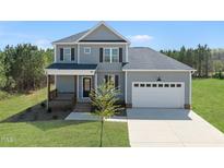 Beautiful two-story home boasting a two-car garage, covered front porch, and a neatly landscaped front yard at 40 Misty Mountain, Spring Hope, NC 27882