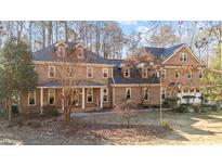 Brick two-story home with landscaped yard and attached garage at 5317 Burning Oak Ct, Raleigh, NC 27606