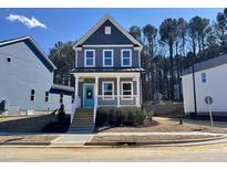 Charming two-story home with a covered porch and a bright blue front door at 136 Weavers Grove Dr, Chapel Hill, NC 27514