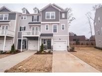 New construction townhome with a one car garage and gray wood siding at 203 Pond Vw Ct # 1, Fuquay Varina, NC 27526
