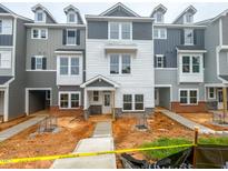 New townhomes with varied neutral tone exteriors boast modern design elements and private entrances at 207 Pond View Ct # 3, Fuquay Varina, NC 27526
