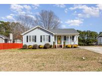Charming single-story home featuring a welcoming front porch, manicured lawn, and stylish curb appeal at 3332 Castlegate Dr, Raleigh, NC 27616