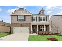 Charming two-story home featuring a brick and siding exterior with a two-car garage at 107 Ethel Ln, Angier, NC 27501