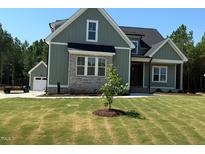 Charming exterior view of a well-manicured house with an attached garage and a beautiful, green lawn at 136 Bar Code Ct, Wendell, NC 27591