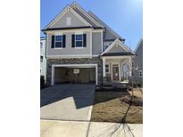 Charming two-story home featuring stone accents, a two-car garage, and a welcoming front porch at 2391 Englemann Dr Dr # 124, Apex, NC 27502
