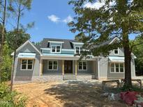 Charming exterior of a home with stone accents, complemented by a well-manicured lawn and inviting entrance at 172 Quail Pt, Pittsboro, NC 27312