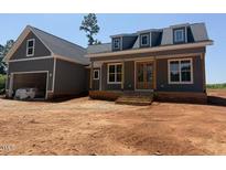 Charming home with gray siding, a covered porch, and well-manicured landscaping at 2850 Sheep Pasture Rd, Spring Hope, NC 27882