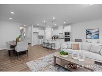 Open-concept living room boasts an island kitchen, dining area and comfortable seating at 3934 Well Fleet Drive, Fuquay Varina, NC 27526