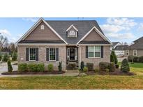 Charming brick home featuring well-maintained landscaping and a welcoming entrance at 4236 Aviemore, Burlington, NC 27215