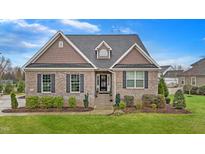Charming brick home with well-manicured landscaping and a classic architectural design in a suburban neighborhood at 4236 Aviemore, Burlington, NC 27215