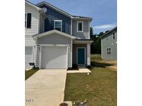 Charming two-story home featuring a one car garage and beautifully landscaped front yard at 10548 Brookside Reserve Rd, Raleigh, NC 27614