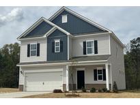 Charming two-story home with blue and grey siding and an attached two car garage at 165 Knoll Way, Sanford, NC 27332