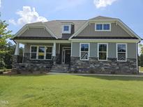 Charming home featuring stone accents, neutral siding, and inviting front porch at 200 Ironwood Lot 39 Blvd, Youngsville, NC 27596