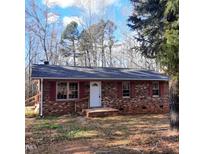 Brick ranch house with red shutters, and a small front porch at 2800 Coleman Loop Rd, Hillsborough, NC 27278