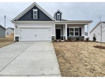 Charming single-Gathering home with a two-car garage and inviting covered front porch at 166 Vega Loop, Sanford, NC 27330