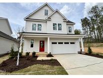 Charming two-story home featuring a bright red door and a two-car garage at 105 Windchime Ct, Fuquay Varina, NC 27526