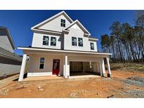 Two-story home featuring white siding, a red front door, and an attached garage at 105 Windchime Ct, Fuquay Varina, NC 27526