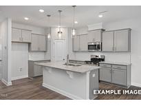 Stylish kitchen with stainless steel appliances and ample counter space at 3932 Well Fleet Drive, Fuquay Varina, NC 27526