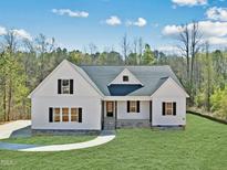 Charming white home with black shutters and a well-manicured lawn on a sunny day at 40 Moonraker Dr, Spring Hope, NC 27882