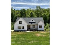 Charming home showcasing a bright green lawn and pristine white siding at 40 Moonraker Dr, Spring Hope, NC 27882